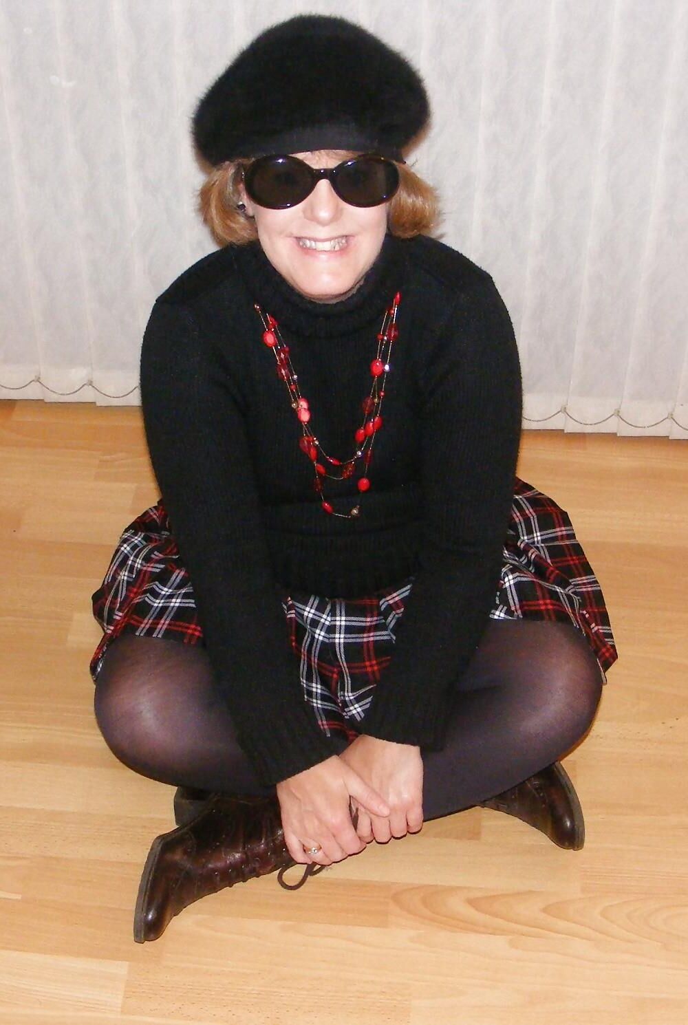 Chubby wife in short tartan skirt and shiny tights