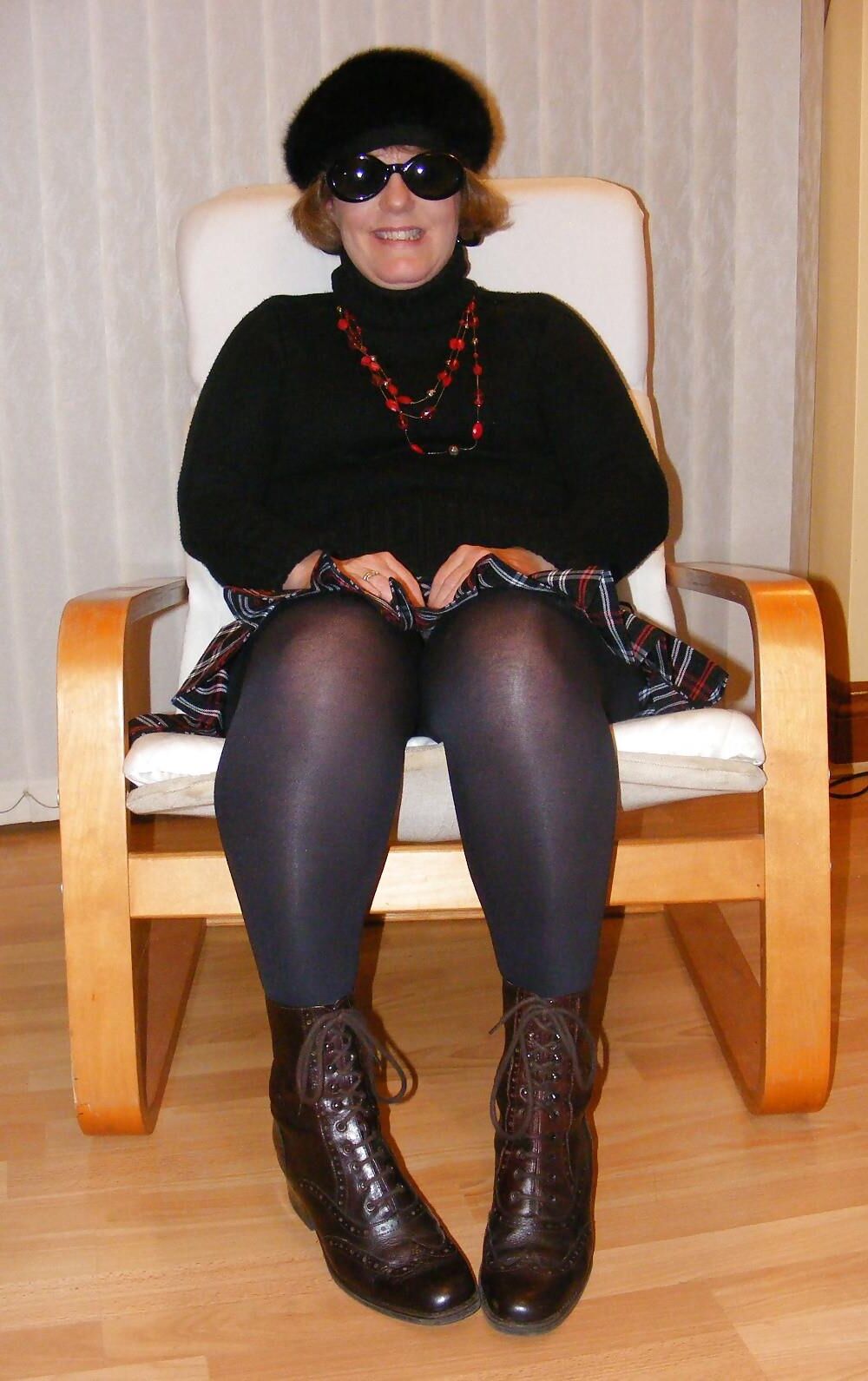 Chubby wife in short tartan skirt and shiny tights