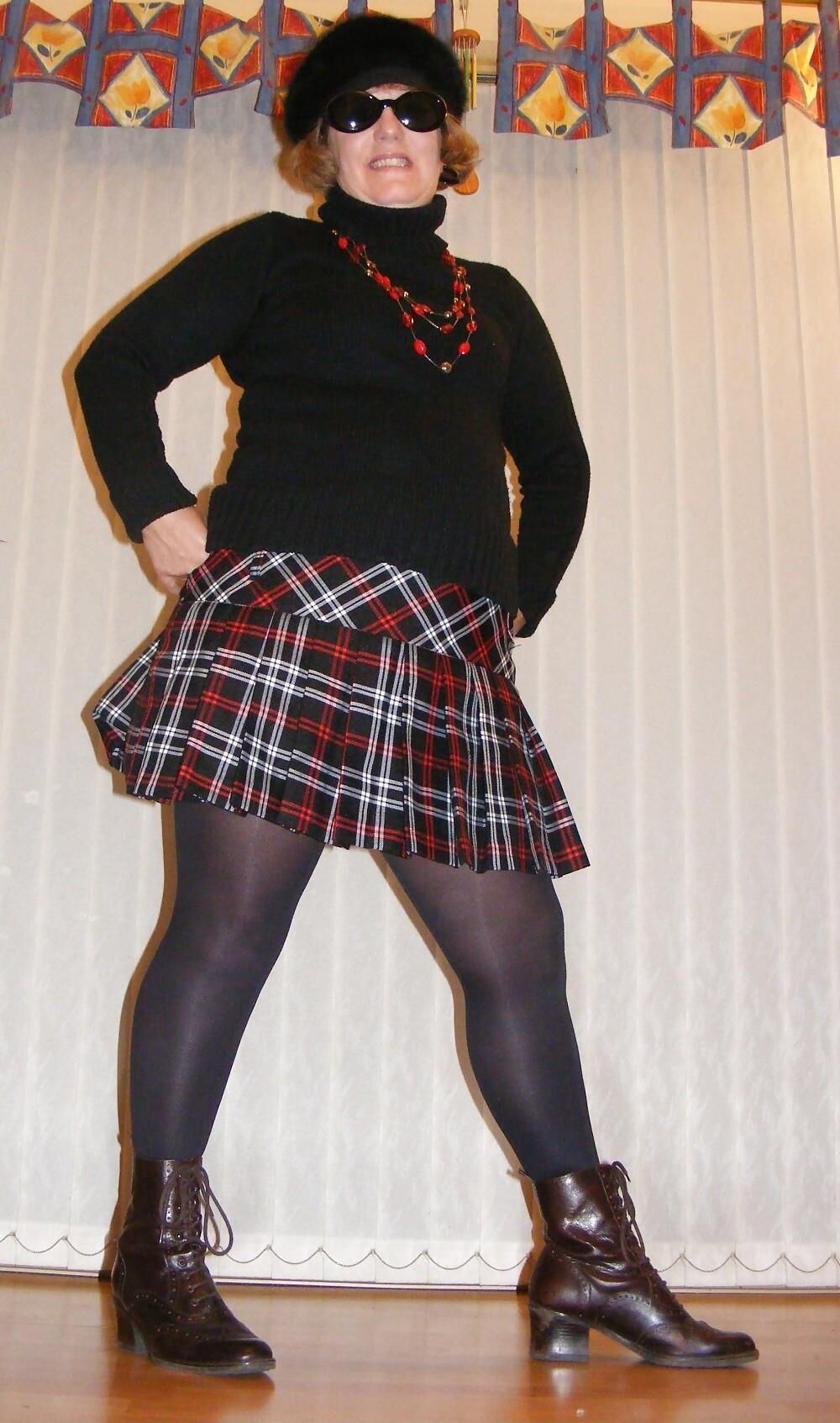 Chubby wife in short tartan skirt and shiny tights