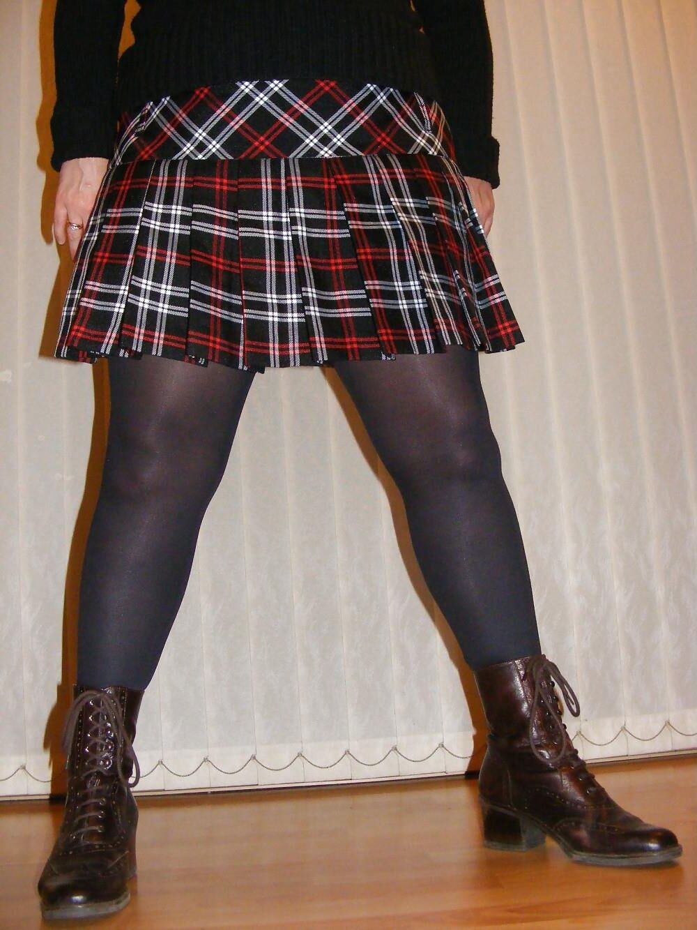 Chubby wife in short tartan skirt and shiny tights