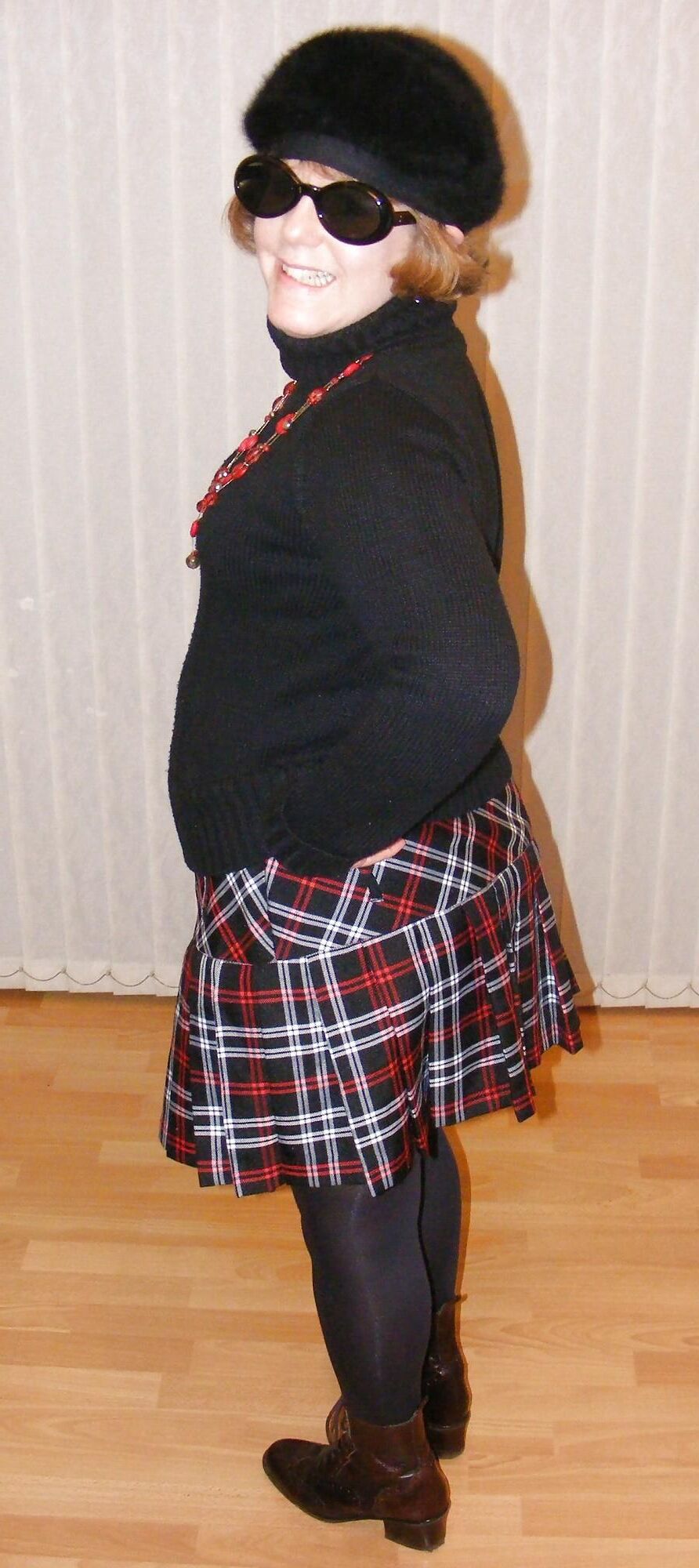 Chubby wife in short tartan skirt and shiny tights