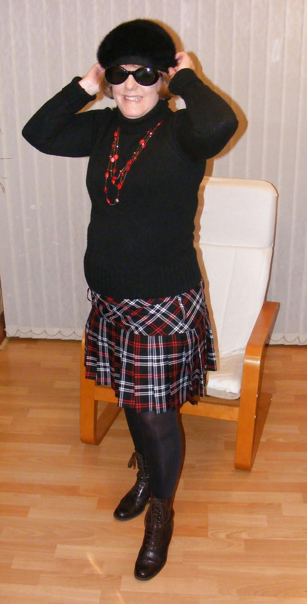 Chubby wife in short tartan skirt and shiny tights