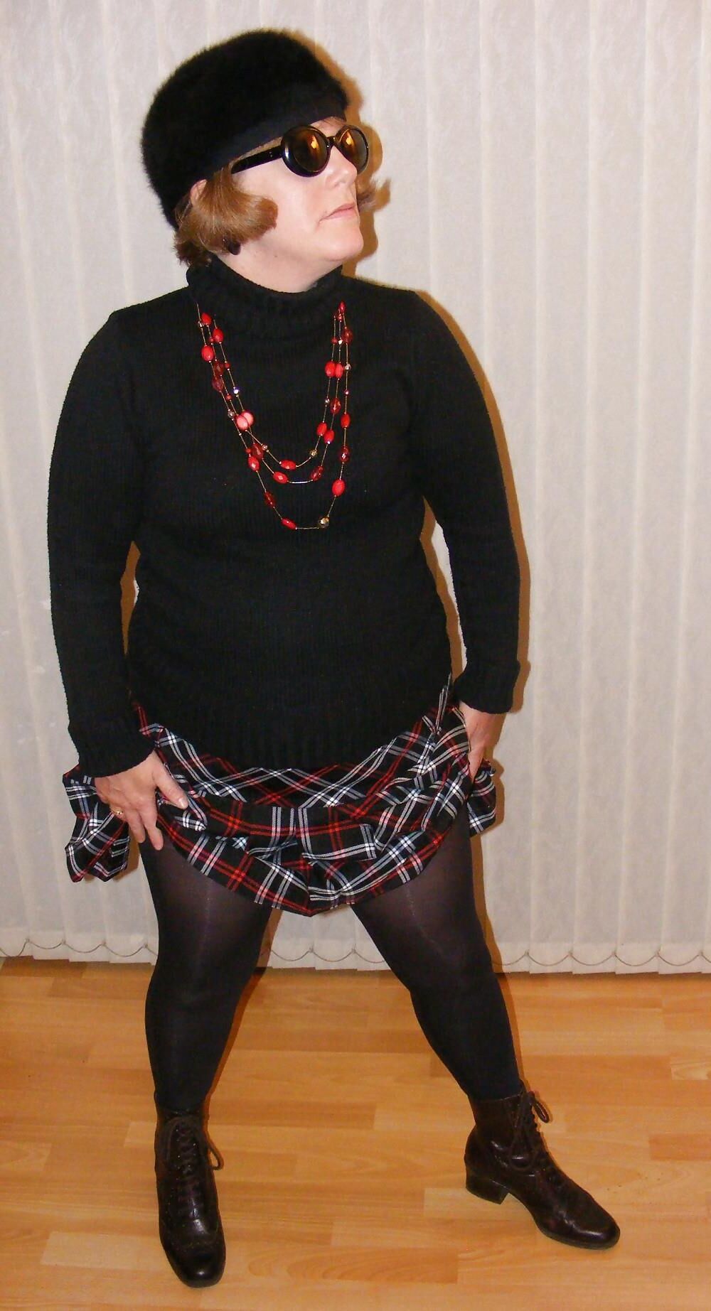 Chubby wife in short tartan skirt and shiny tights