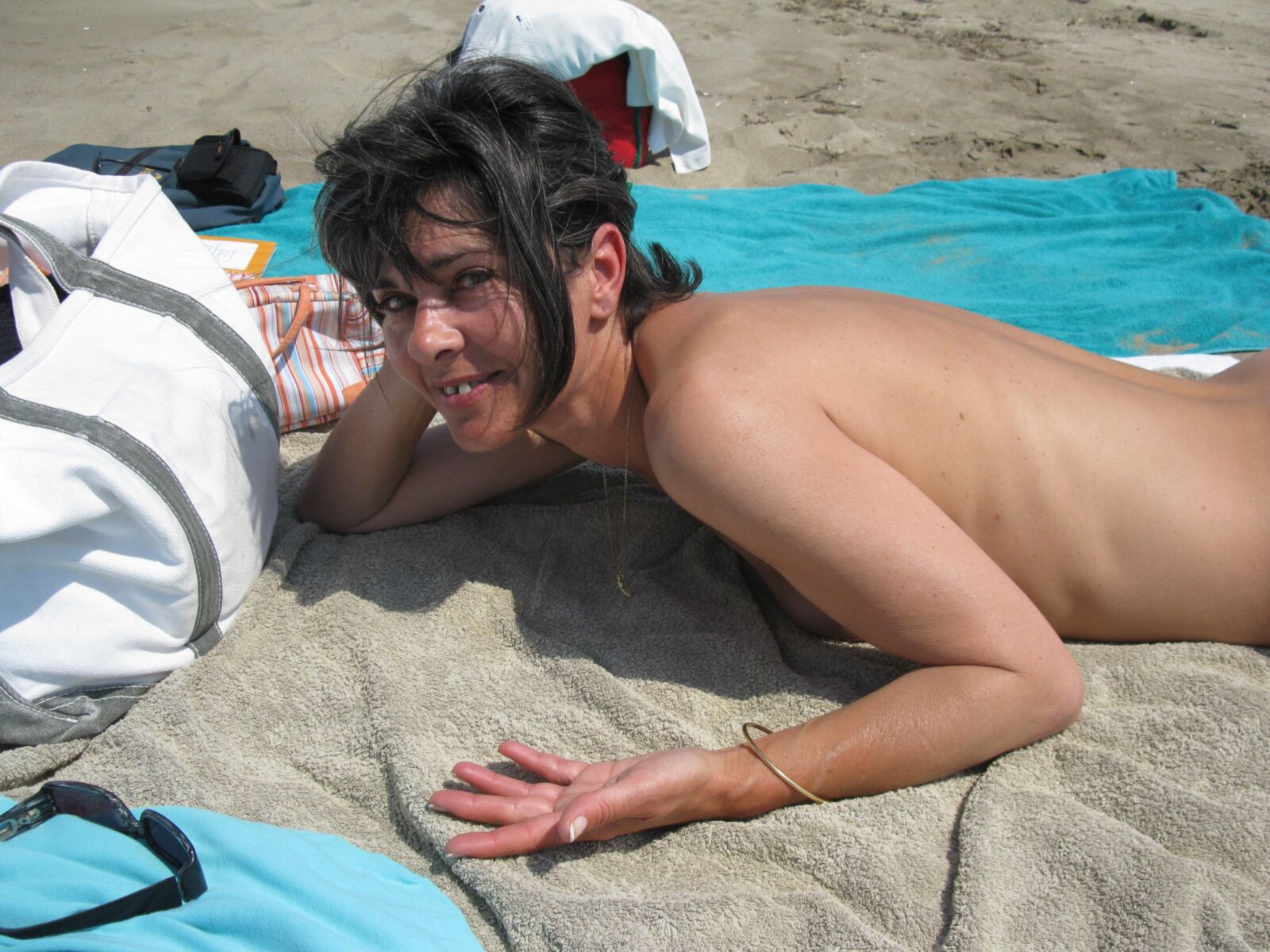 Skinny mature Beatrice on beach smiling and spreading legs HD