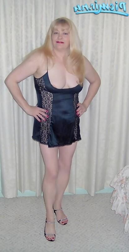 Mature blonde posing with army equipment and in underwear