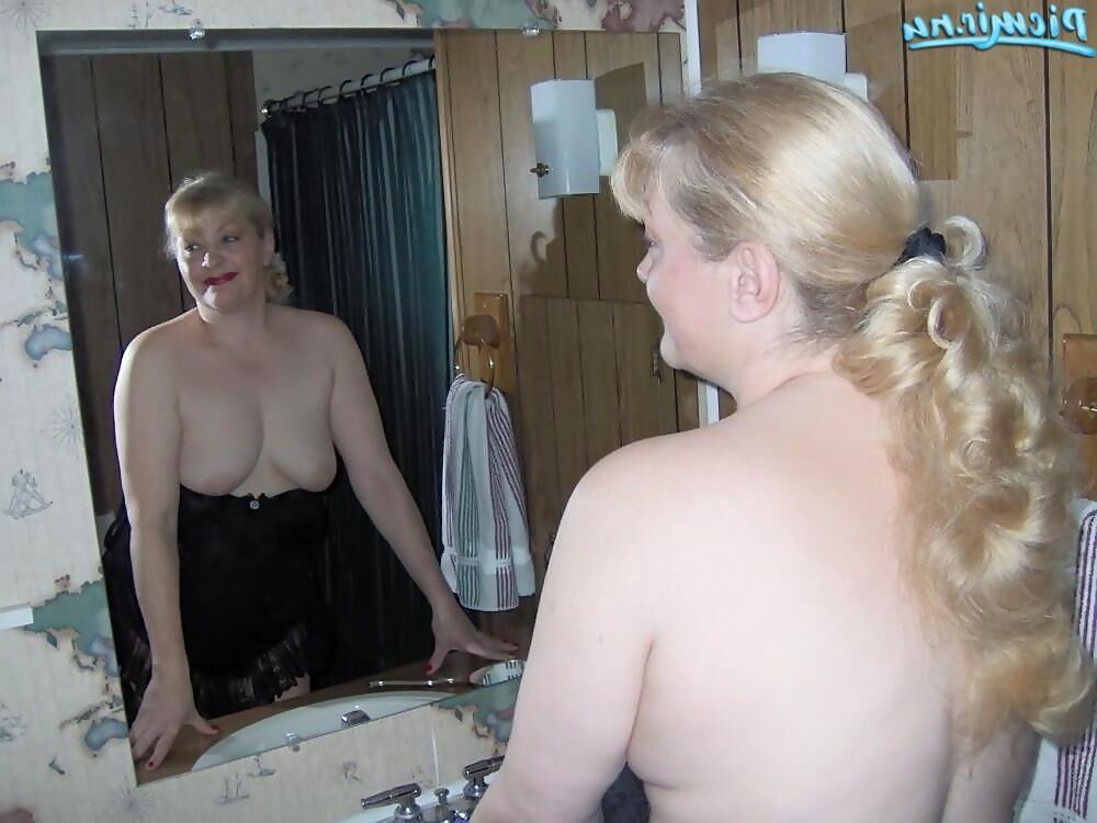 Mature blonde posing with army equipment and in underwear
