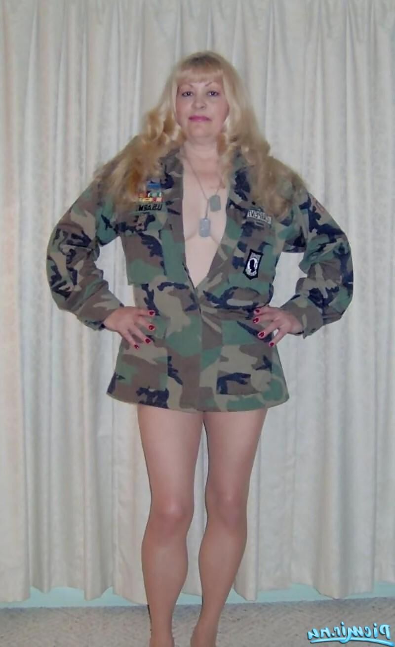 Mature blonde posing with army equipment and in underwear