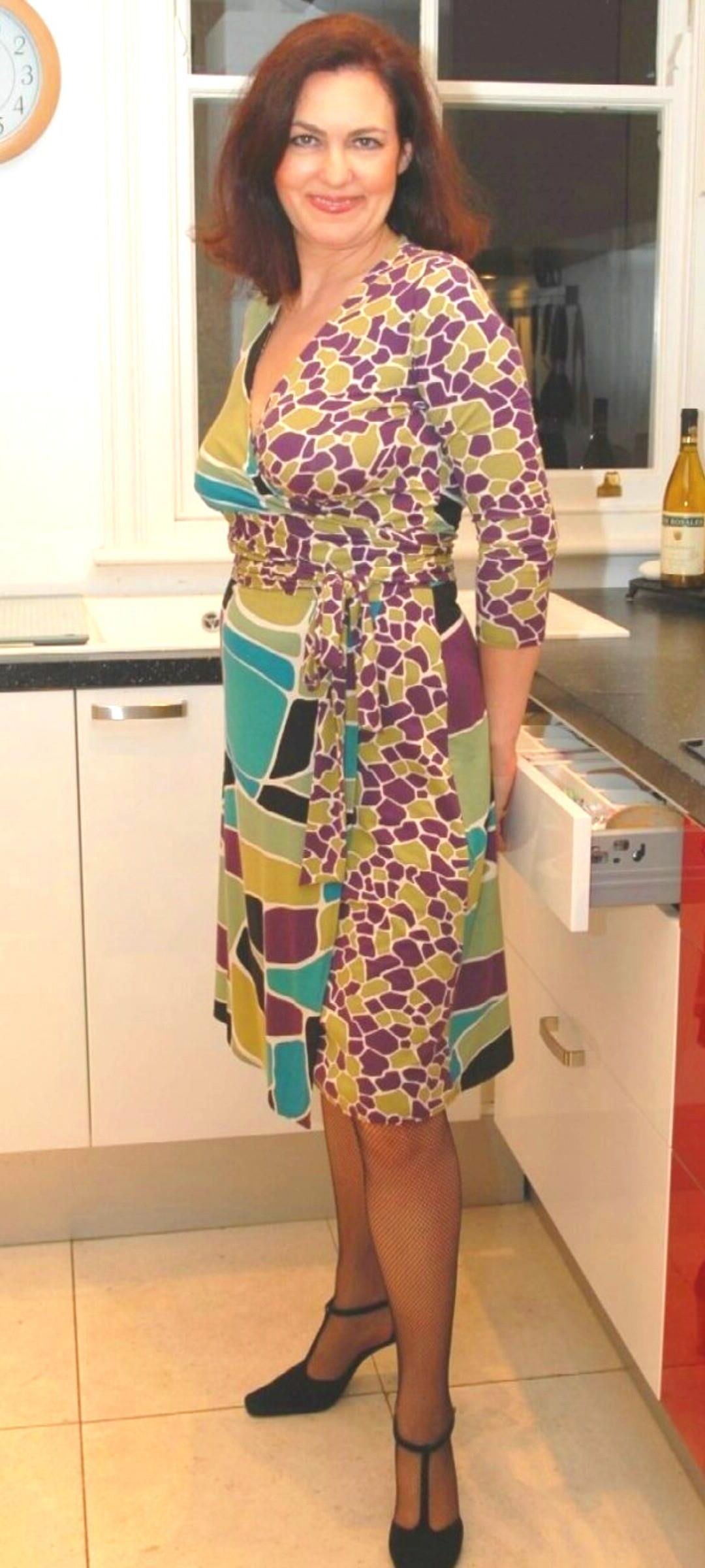Mature undresses in the kitchen
